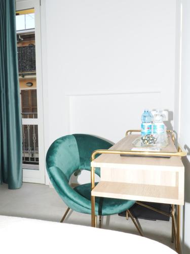 a room with a table and a green chair at CASA di LU in Civitanova Marche