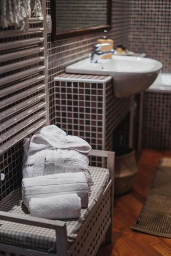a bathroom with a rack of towels and a sink at Villa ElSi, Where Relaxation and Elegance Meet in Valenzano