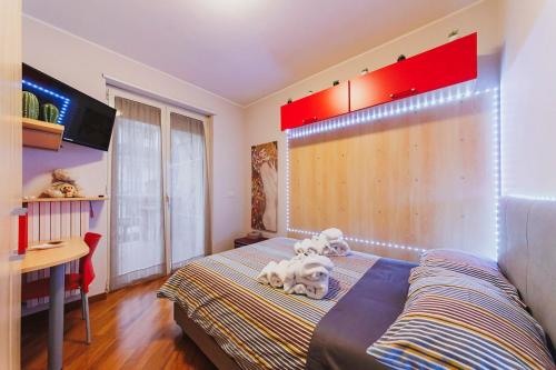 two dogs sitting on a bed in a bedroom at Villa ElSi, Where Relaxation and Elegance Meet in Valenzano