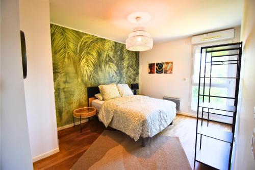 a bedroom with a bed and a palm mural at Le Bicolore Parisien in Aubervilliers