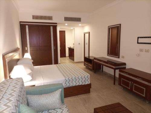 a hotel room with a bed and a desk at Oyster bay resort studio in Marsa Alam