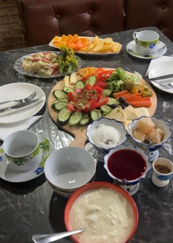 a table topped with plates and bowls of food at Mamuka's Guesthouse in Udabno