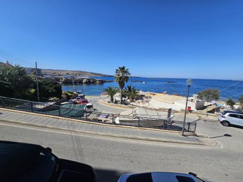 a road with a view of a beach and the ocean at Sea VIEW holiday home in St Paul's Bay
