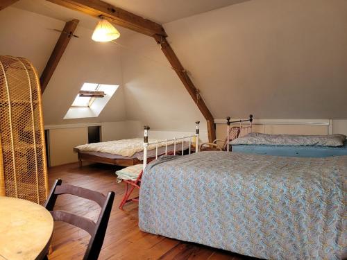 une chambre avec deux lits et une table et une fenêtre dans l'établissement Maison calme avec jardin fleuri, à Vannes