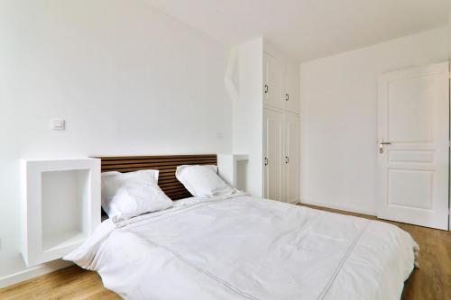 - une chambre blanche avec un grand lit blanc et 2 oreillers dans l'établissement Incredible T2 - La plaine - Very well located, à Marseille