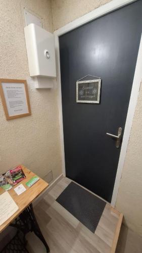 a door with a sign on it next to a table at La petite Brézègue in Aguessac