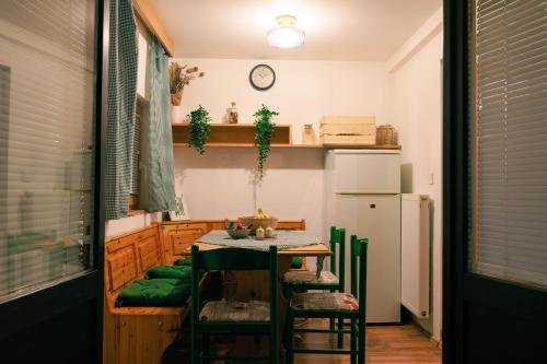 a small kitchen with a table and a refrigerator at Honeydew Cottage in camp Terme Čatež in Čatež ob Savi