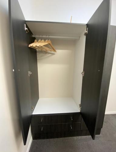 a walk in closet with a black cabinet at Roantree House in Portland