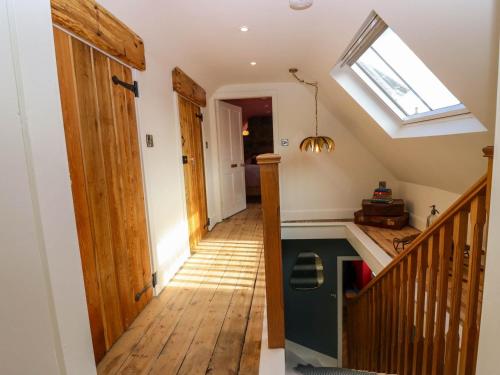 a hallway with a staircase and a skylight at Evansford in Ballater