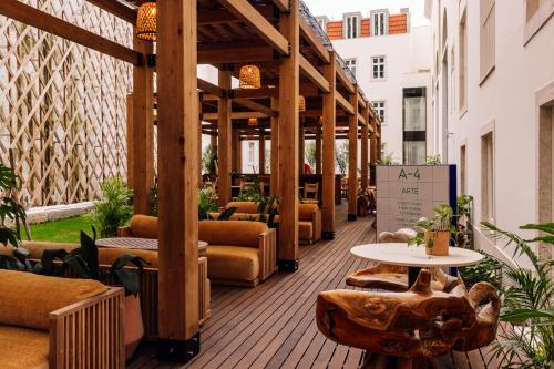 a patio with couches and tables on a building at Locke de Santa Joana in Lisbon