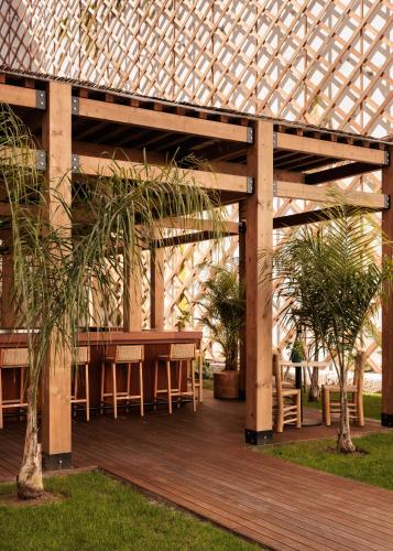 a wooden pergola with a table and chairs on a deck at Locke de Santa Joana in Lisbon