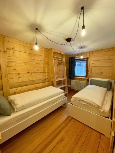 a bedroom with two beds and a bunk bed at Da Nonno Nani in Venas
