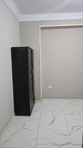 a black tv sitting in the corner of a room at Mid in Madīnat as Sādāt