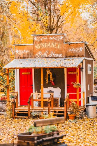 a small play house with a sign on it at Cozy Wild West Covered Wagon next to River in Grants Pass