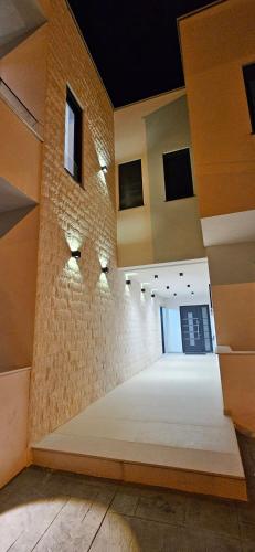 a large empty room with a brick wall at Bahr DELUX App & Suite in Ulcinj