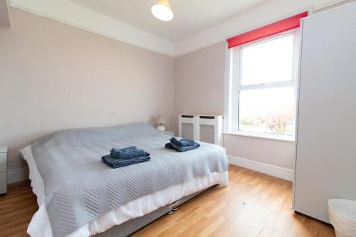 a white bedroom with a bed and a window at Thornbury Guest House Room 7 in Southampton