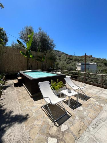 a group of chairs and a swimming pool at Villa Carolina Sorrento Private Heated Pool and Sea View in Sorrento