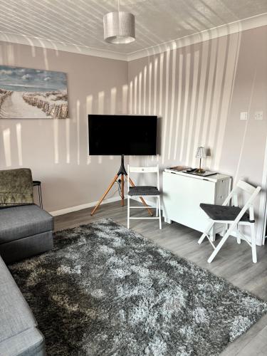 a living room with a flat screen tv on a wall at Flat 3 Seaside Haven in Hunstanton
