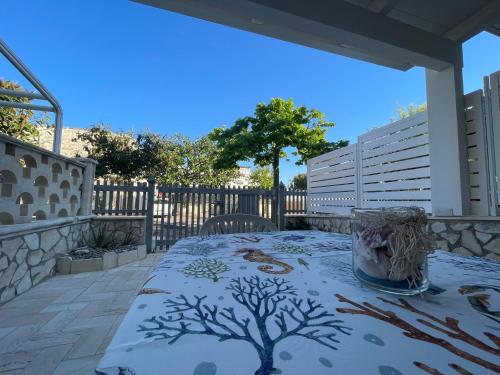 a table with a tree on it on a patio at Lo Scrigno in Torre Canne
