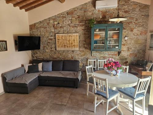 a living room with a couch and a table at La Bottega del Maniscalco in Filettole
