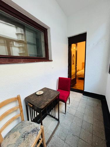 a room with a table and two chairs and a window at Iancu Apartments in Bucharest