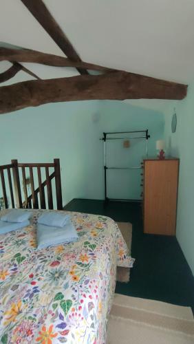 a bedroom with a bed and a dresser at Les Murmures de Charente in Villiers-le-Roux