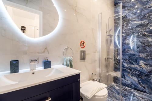 a bathroom with a sink and a shower and a toilet at View of the Ionian Sea, Vournikas in Vournikás