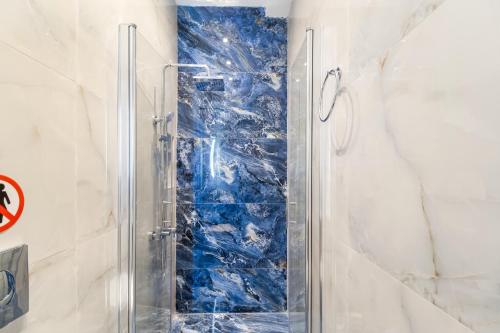 a shower with a glass door in a bathroom at View of the Ionian Sea, Vournikas in Vournikás