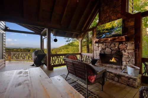 a living room with a fireplace on a porch at Majestic View in Mashburn Mill