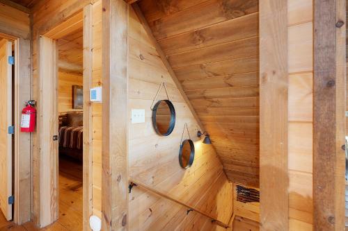 a wooden cabin with two mirrors on the wall at Majestic View in Mashburn Mill