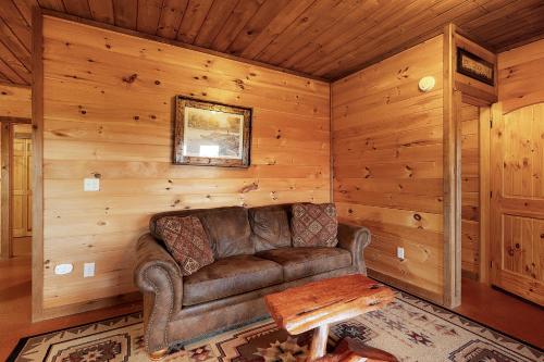 a living room with a leather couch and a table at Majestic View in Mashburn Mill