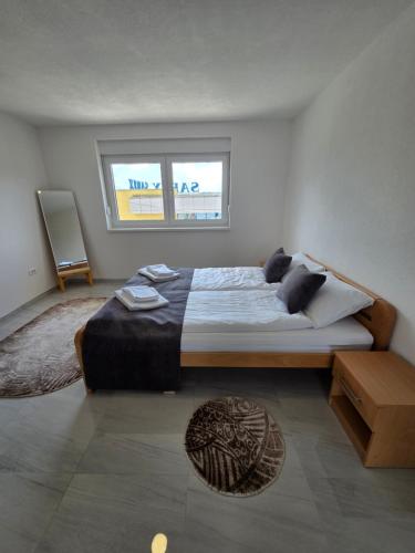 a bedroom with a large bed and two windows at Sarajevo Pulse Residence in Sarajevo