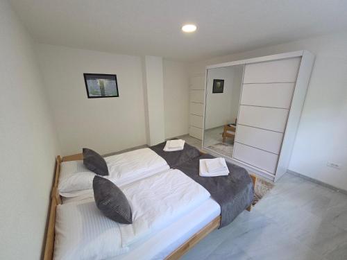 a bedroom with a large bed and a large mirror at Sarajevo Pulse Residence in Sarajevo