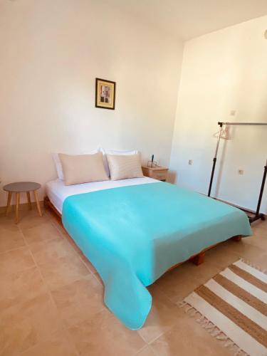 a large blue bed in a room with a table at Apartman Nela in Betina
