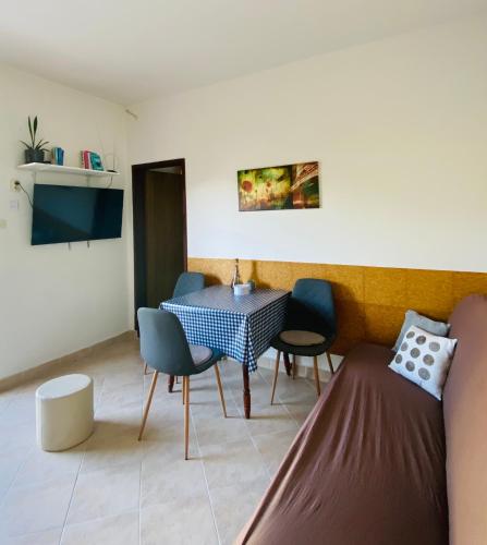 a living room with a table and chairs at Apartman Nela in Betina