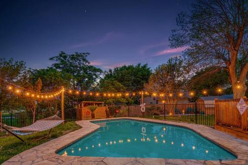 a swimming pool in a yard with lights at Family fun 4bed 2bath with pool in San Antonio