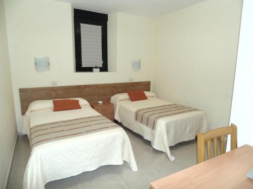 Postel nebo postele na pokoji v ubytování APARTAMENTOS OUTEIRO