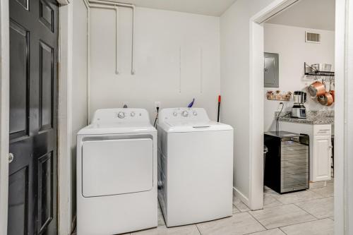 a kitchen with two white washers and a refrigerator at Family fun 4bed 2bath with pool in San Antonio