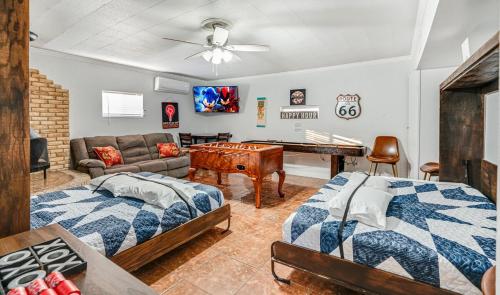 a living room with two beds and a ping pong table at Family fun 4bed 2bath with pool in San Antonio