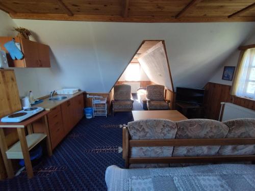 a living room with a couch and a sink at Roubenka Mříčná in Mřičná