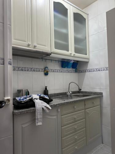 a kitchen with white cabinets and a sink at Estúdio Azul-T0-Torralta-Ocean View by Aura in Alvor