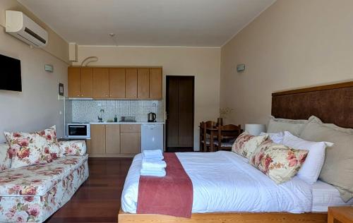 a living room with a bed and a couch at Althea Apartments in Katakolon