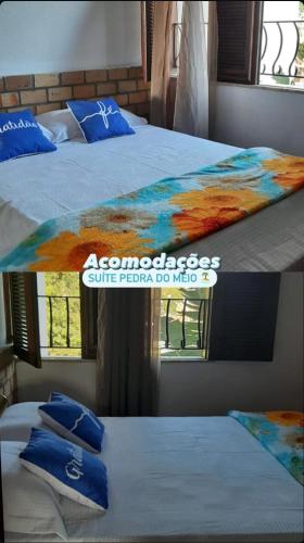 two beds in a room with a painting on the bed at Hotel Pérolas Beach in Paracuru