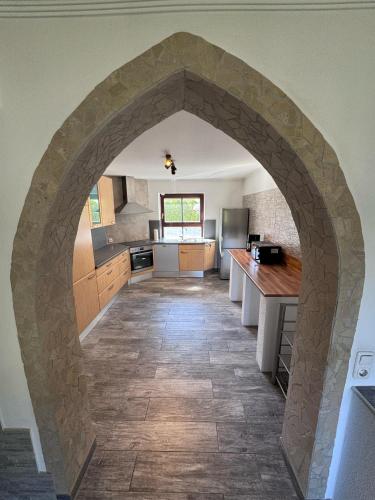 a kitchen with an archway in the middle of a room at Bavaria Home Rohrbach in Rohrbach