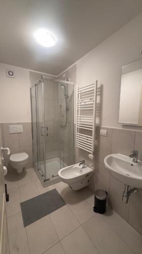 ein Badezimmer mit Dusche, Waschbecken und Toilette in der Unterkunft Duplex in riva al mare in Calambrone