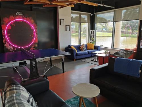 a living room with a ping pong table and couches at For Students Only - The Towpath in Chester in Chester