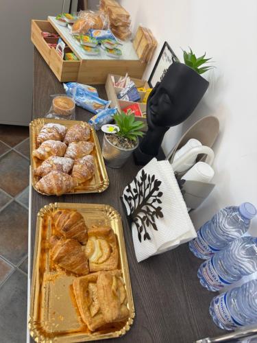 a table with bread and pastries on it at Le Scalette del centro in Agrigento