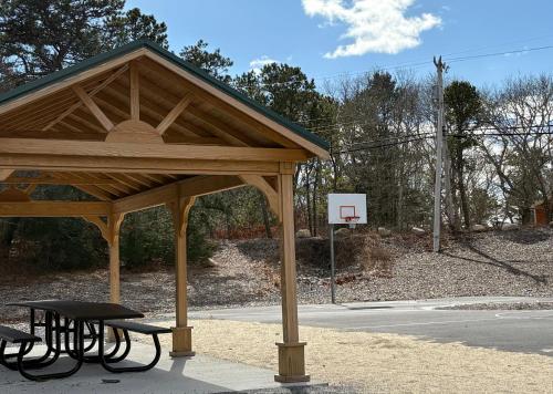 a pavilion with two picnic tables and a basketball hoop at The Perfect Restful Retreat in Wareham