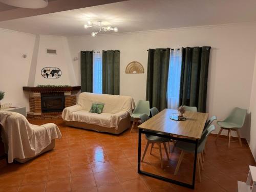 a living room with a couch and a table at Breeze House Almograve - Rooms on Fishermen's Trail in Almograve