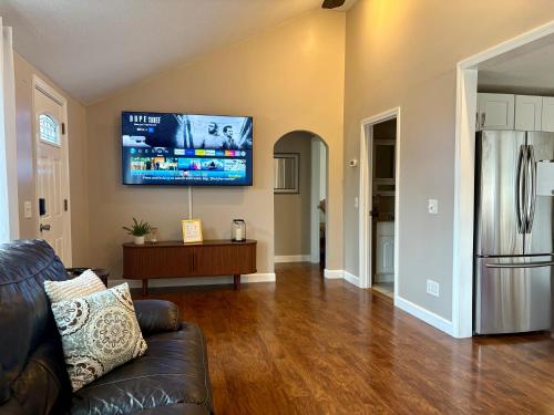 a living room with a couch and a television on the wall at The Perfect Restful Retreat in Wareham